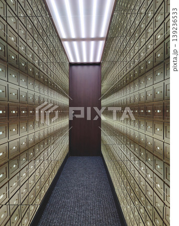 Symmetrical corridor with infinite rows of wooden safe deposit boxes and bright overhead fluorescent lighting Symmetrical corridor with infinite rows of wooden safe deposit boxes and bright overhead fluorescent lighting 139236533