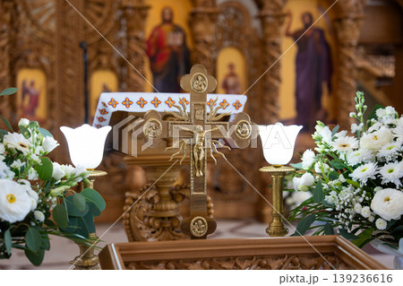 Golden altar cross with rays and floral background Golden altar cross with rays and floral background 139236616