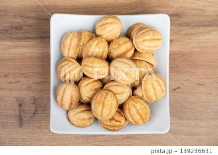 Traditional "Oreshki" walnut-shaped cookies in a white square bowl Traditional "Oreshki" walnut-shaped cookies in a white square bowl 139236631