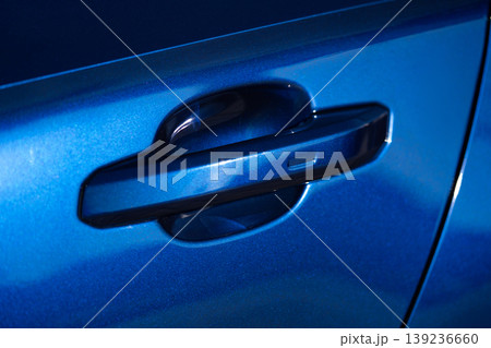 Close-up of a car door handle on a dark blue metallic sedan 139236660