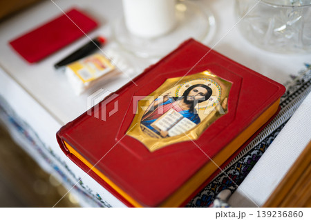 Red liturgical Gospel book with an icon of Jesus Christ Red liturgical Gospel book with an icon of Jesus Christ 139236860