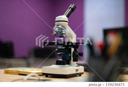 professional microscope in a school laboratory for the study of cells and bacteria 139236871