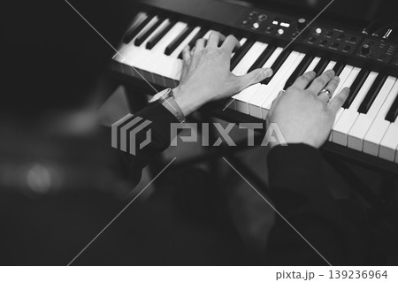 close-up of a pianist's hands while playing the piano close-up of a pianist's hands while playing the piano 139236964