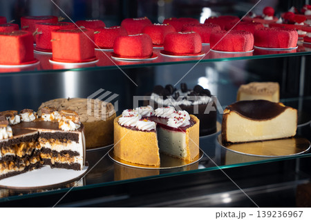 Variety of gourmet cakes and pastries in a bakery display case Variety of gourmet cakes and pastries in a bakery display case 139236967
