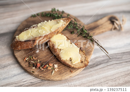 breakfast of sandwich with butter on a wooden board 139237511