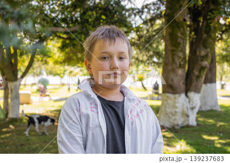 Happy young boy portrait. Child playing in park outdoors 139237683