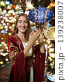 Young girl in Ottoman dress posing in traditional Turkish lamp shop in Turkey 139238007