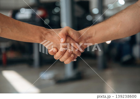 Handshake of man and woman in the car repair service station Handshake of man and woman in the car repair service station 139238600