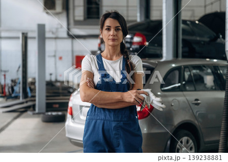 Front view. Female mechanic is working in the modern car workshop Front view. Female mechanic is working in the modern car workshop 139238881