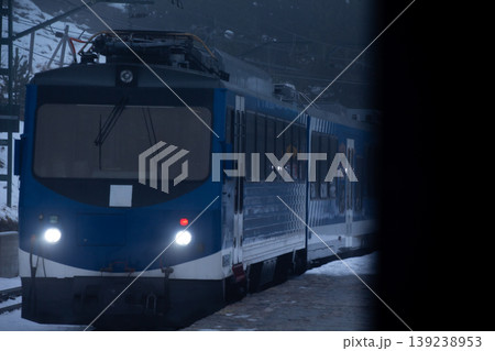 Blue Train on Snowy Tracks in Winter Landscape Blue Train on Snowy Tracks in Winter Landscape 139238953