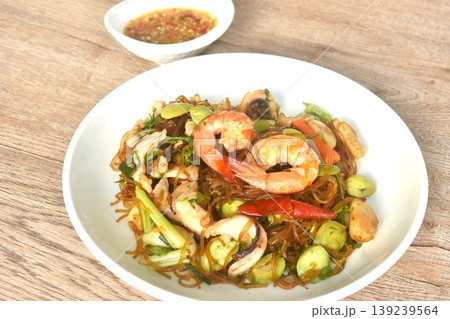 stir-fried glass noodles with three stinky vegetables and shrimp couple squid on plate dipping spicy chili sauce stir-fried glass noodles with three stinky vegetables and shrimp couple squid on plate dipping spicy chili sauce 139239564