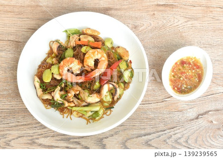 stir-fried glass noodles with three stinky vegetables and shrimp couple squid on plate dipping spicy chili sauce stir-fried glass noodles with three stinky vegetables and shrimp couple squid on plate dipping spicy chili sauce 139239565