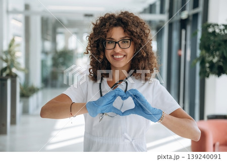 Heart, love gesture by hands. Woman doctor is standing indoors in the clinic 139240091