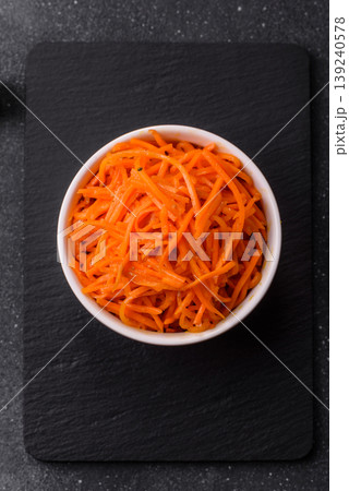 Spicy Korean carrot salad, grated with salt and spices, an Asian dish. Korean carrots Spicy Korean carrot salad, grated with salt and spices, an Asian dish. Korean carrots 139240578