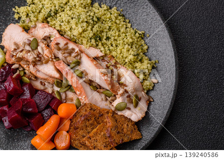A bowl with chicken or turkey, porridge, vegetables, sauce, and spices. A meat bowl A bowl with chicken or turkey, porridge, vegetables, sauce, and spices. A meat bowl 139240586