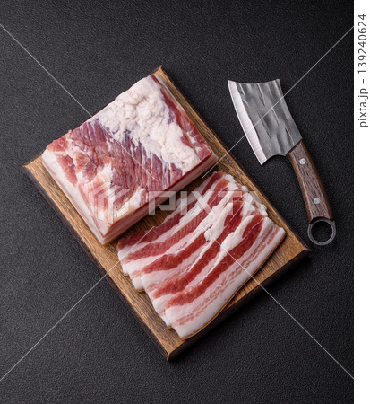 Raw fresh bacon slices with layers of meat or prosciutto prepared for frying. Raw bacon 139240624