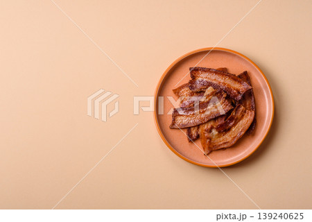 Fried fresh bacon slices with layers of meat or prosciutto prepared for breakfast. Fried bacon 139240625