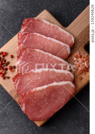 Smoked or dry cured meat slices, pork or ham with salt and spices. Smoked meat slices 139240626