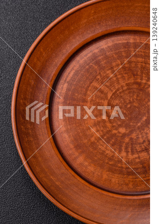An empty ceramic round plate, kitchen utensils for a dinner table. An empty plate 139240648