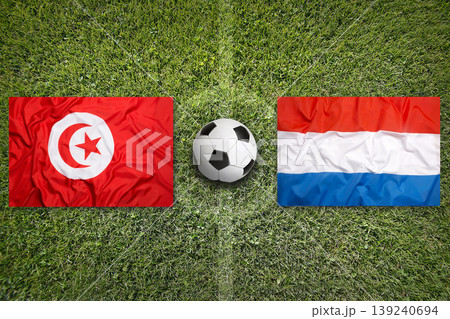 Tunisia vs. Netherlands flags on a soccer field Tunisia vs. Netherlands flags on a soccer field 139240694