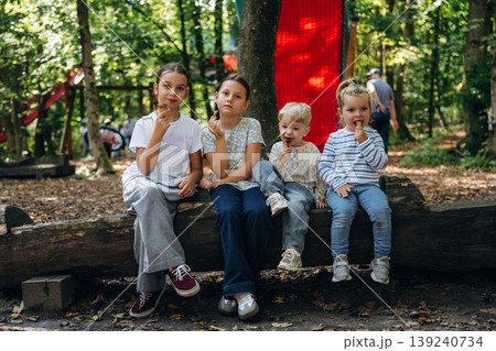 Eating ice cream. Group of kids are having fun together in the park 139240734