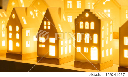 Glowing ceramic miniature houses with warm internal light Glowing ceramic miniature houses with warm internal light 139241027