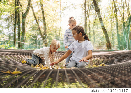 Kids are playing on the children's amusement ropes course 139241117