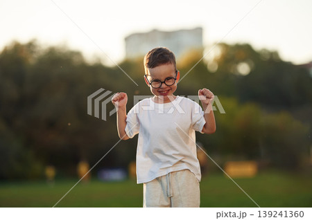 Boy is having fun on the field under sunlight at daytime 139241360