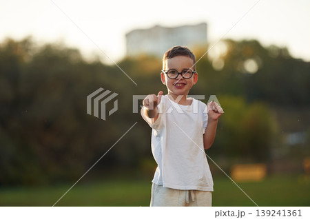Boy is having fun on the field under sunlight at daytime Boy is having fun on the field under sunlight at daytime 139241361