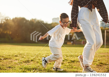 Mother and son together in an open field during daytime Mother and son together in an open field during daytime 139241532