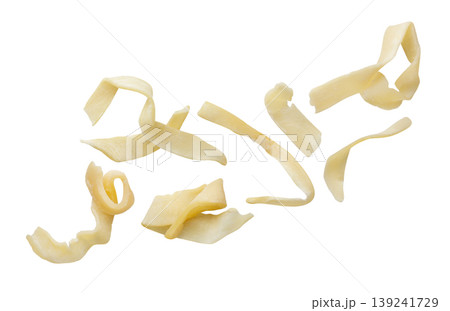 Pieces of dried squid flying on a white background. Isolated 139241729