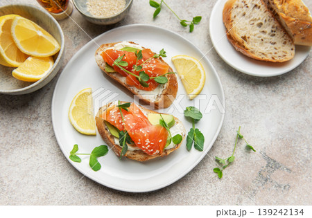 Salmon bruschetta with cream cheese and avocado slices 139242134