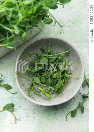 Harvesting fresh pea shoots in a bowl 139242183