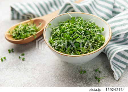 Fresh microgreens in bowl and wooden spoon 139242184
