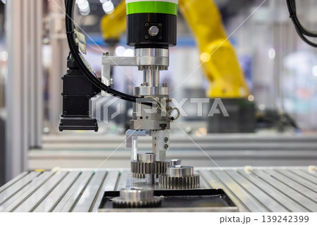 Industrial robotic arm with machine vision camera picking metal gears in automated factory line, Robotic gripper handling steel machine, Automated robotic system smart factory. Industrial robotic arm with machine vision camera picking metal gears in automated factory line, Robotic gripper handling steel machine, Automated robotic system smart factory. 139242399
