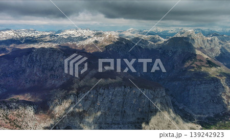 Aerial view of rocky mountain peak and green valley Aerial view of rocky mountain peak and green valley 139242923