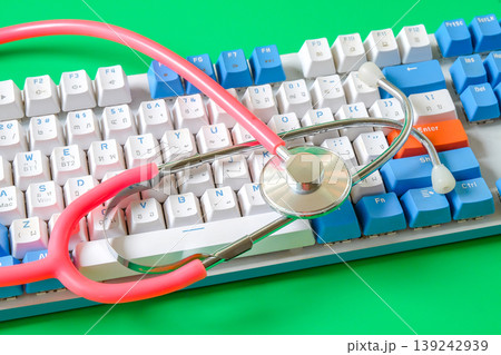 A stethoscope resting on a computer keyboard. A stethoscope resting on a computer keyboard. 139242939