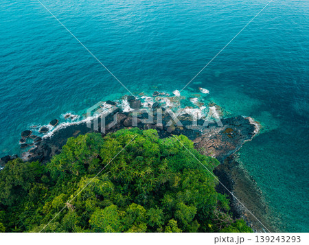 Beautiful tropical island coastline with lush green jungle and clear water. Beautiful tropical island coastline with lush green jungle and clear water. 139243293