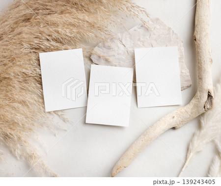 Blank wedding cards suite mockup with pampas grass on beige stone top view, boho wedding stationery 139243405