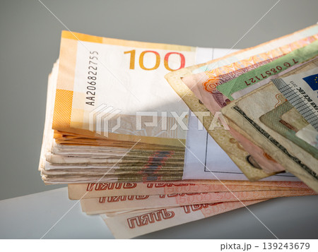 Stack of paper banknotes representing currency and financial wealth. Cash savings and international money exchange concept. Economics, banking, business investment and personal finance management. Stack of paper banknotes representing currency and financial wealth. Cash savings and international money exchange concept. Economics, banking, business investment and personal finance management. 139243679
