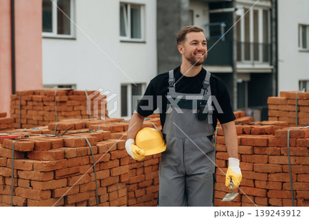 Friendly and positive facial expression. A builder is working at the construction site at daytime 139243912