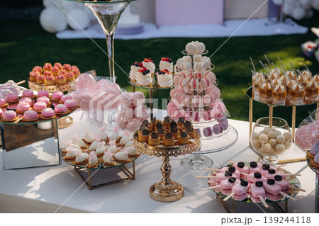 Served for the event. Party table with lot of sweets, desserts. Conception of celebration Served for the event. Party table with lot of sweets, desserts. Conception of celebration 139244118