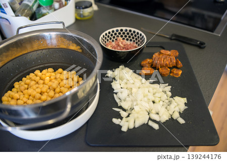 Ingredients for chickpeas with chorizo in a domestic kitchen counter Ingredients for chickpeas with chorizo in a domestic kitchen counter 139244176