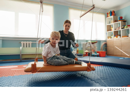 Preschool child with teacher during developmental activities in a playroom 139244261