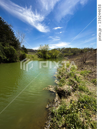Peaceful Pond Landscape with Blue Sky and Reflections in Nature Peaceful Pond Landscape with Blue Sky and Reflections in Nature 139244658