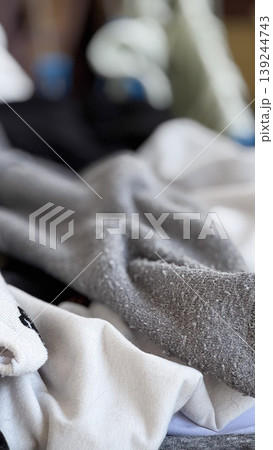 Soft Textiles Piled Together in a Cozy Setting 139244743