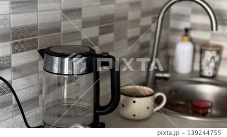 Modern Kitchen Scene with Electric Kettle and Coffee Mug Modern Kitchen Scene with Electric Kettle and Coffee Mug 139244755