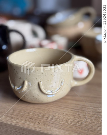 Unique Handcrafted Ceramic Mug on Wooden Table 139245033