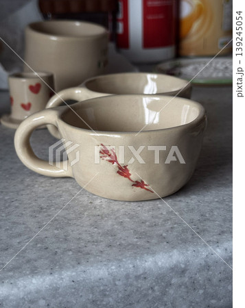 Rustic Handmade Ceramic Cups with Floral Design 139245054
