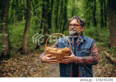 Walking, collected lot of them, in basket. Mushroom picking. Man is in the forest at daytime 139245200